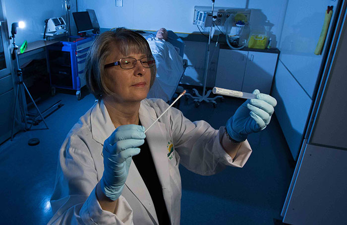 Sheila Early in a forensics lab with a cotton swab test